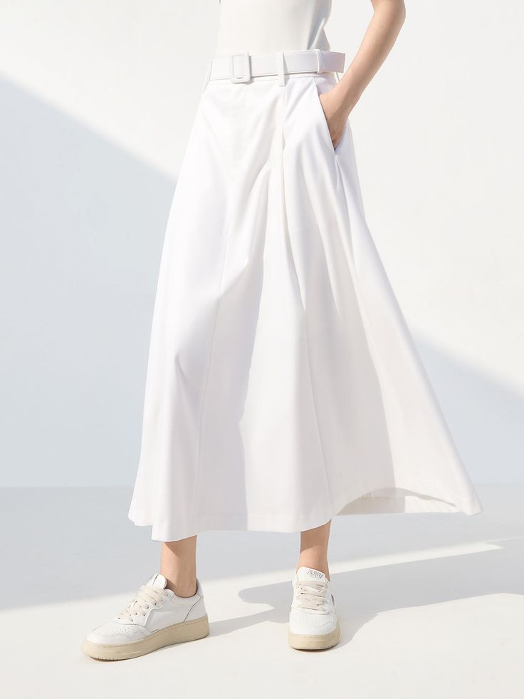 MO&Co. Women's High Waist A-Line Skirt with Belt Features : - Belt include- High waist A-line silhouette- Double side pocket design- Button and zip closure Code: MBC1SKTT05 & MBD1SKTT31The back length of size S is 86.5cmMATERIALS & CARE Material: 61.8% Polyester 36.6% Viscose 1.6% SpandexGentle machine wash below 30°CDo not bleach, hang to dryDo not tumble dry, low ironDo not soak, do not expose to the sunWash with neutral detergentMesh bag, wash with like colorsNote: Remove accessories before w