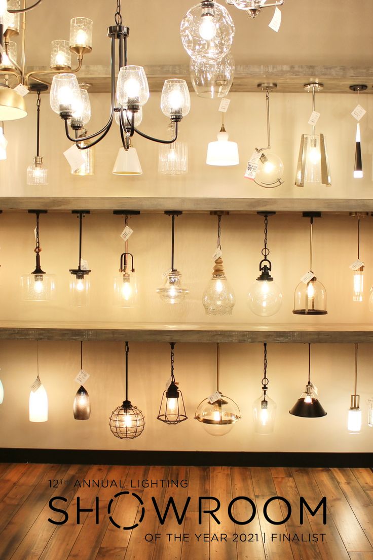 an image of a showroom with chandeliers hanging from the ceiling and lights on the wall