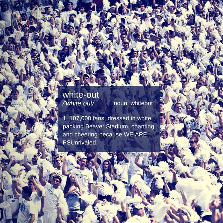 a large group of people standing in front of a white out sign with words above it