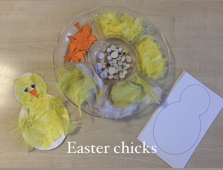 an easter chick craft is shown on a table with paper plates and other items to make it