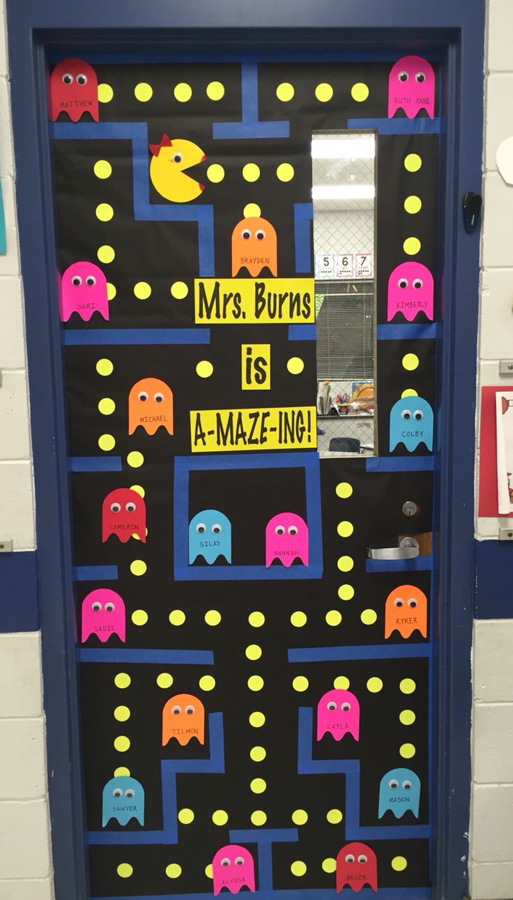 this door is decorated with pac - man characters and the words, mrs burns is a mazeing