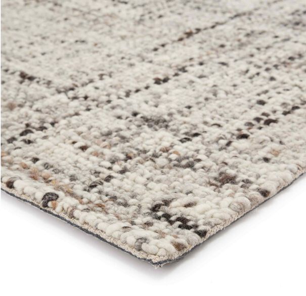 an area rug with various colors and patterns on it, including greys, browns, and whites