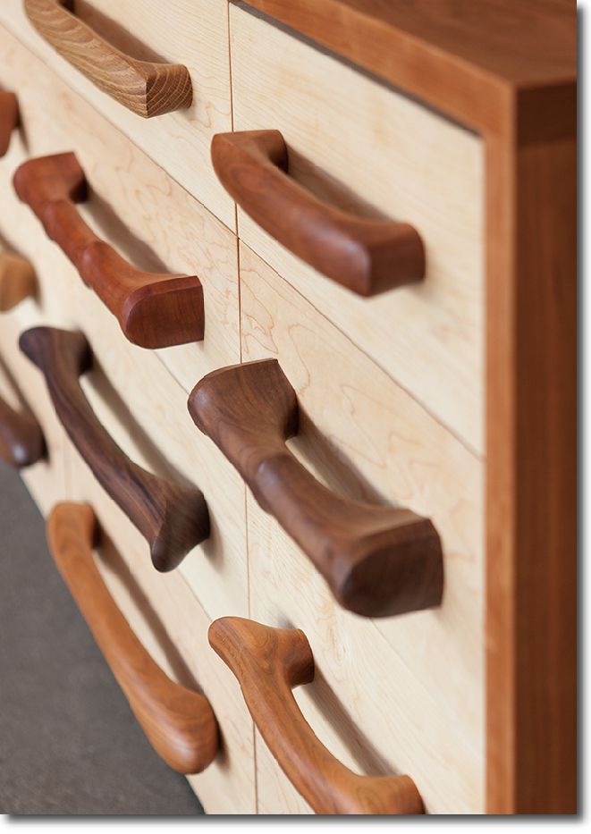 a close up of a drawer with wooden handles