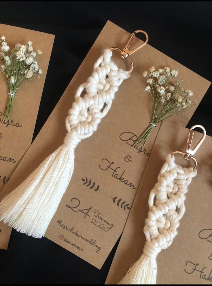 the wedding stationery is decorated with flowers and tassels for guests to use