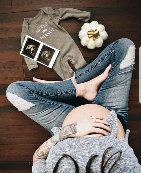 a pregnant woman laying on the floor with her belly exposed