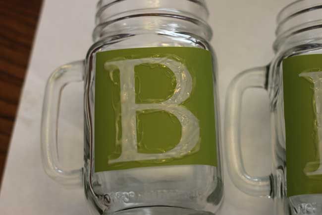 two mason jars with the letter b painted on them