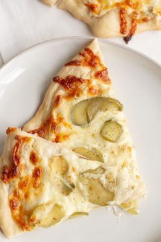 two slices of pizza sitting on top of a white plate