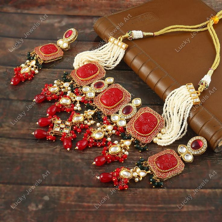 This is a stunning handmade choker necklace perfect for high end Jewelry Collector, a keeper in Traditional Vintage Indian/Pakistani Bridal jewelry and a Luxury Gift for your Daughter, Sister or Wife on Wedding or Anniversary. Perfect for any type of occasions, weddings And celebrations and a beautiful & memorable gift for weddings and special occasions. Description  Item Code:-  Gold Plated Carved Flower & Red Onyx Beaded Choker Necklace Necklace Measures- Adjustable with a Dori/Cord Earring Measures- 100x25mm approx Quantity- One Necklace Set Please see more different designs here:- https://www.etsy.com/in-en/shop/LUCKYJEWELSART?ref=seller-platform-mcnav I make every item of my collection with a lot of love and care, I pay attention to every detail.  You are more than welcome to contact Red Meenakari Choker As A Gift, Traditional Red Meenakari Choker, Luxury Red Kundan Necklace, Red Meenakari Choker Necklace, Handmade Choker Necklace, Pakistani Bridal Jewelry, Luxury Red Multi-stone Necklaces, Handmade Chokers, Diamond Choker