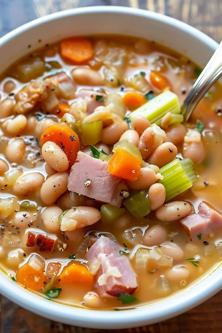 a white bowl filled with ham and bean soup