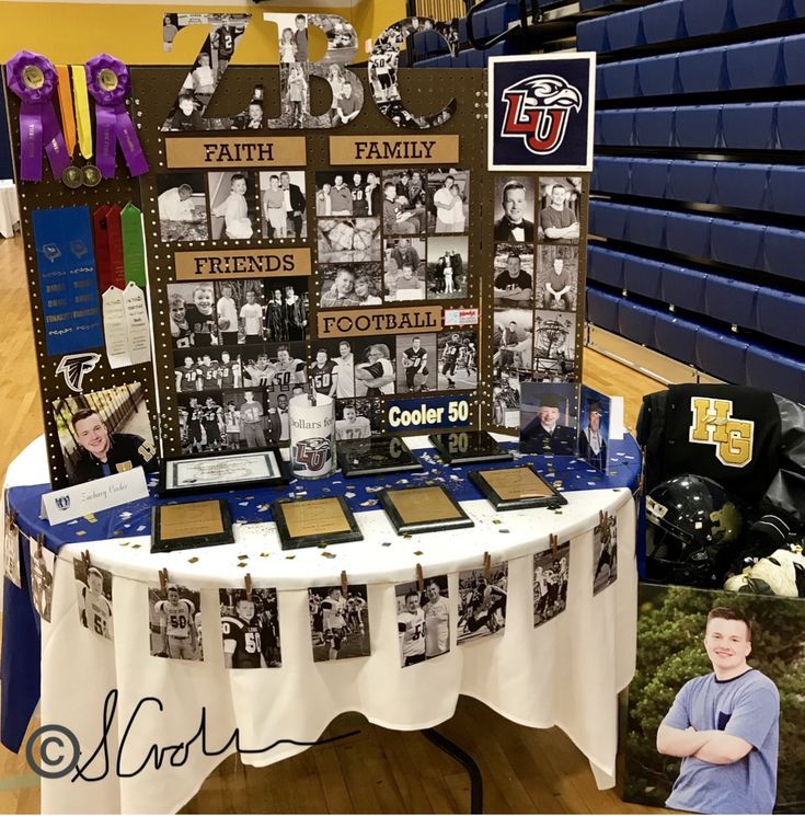 a table that has pictures on it with people in the background at a sports event