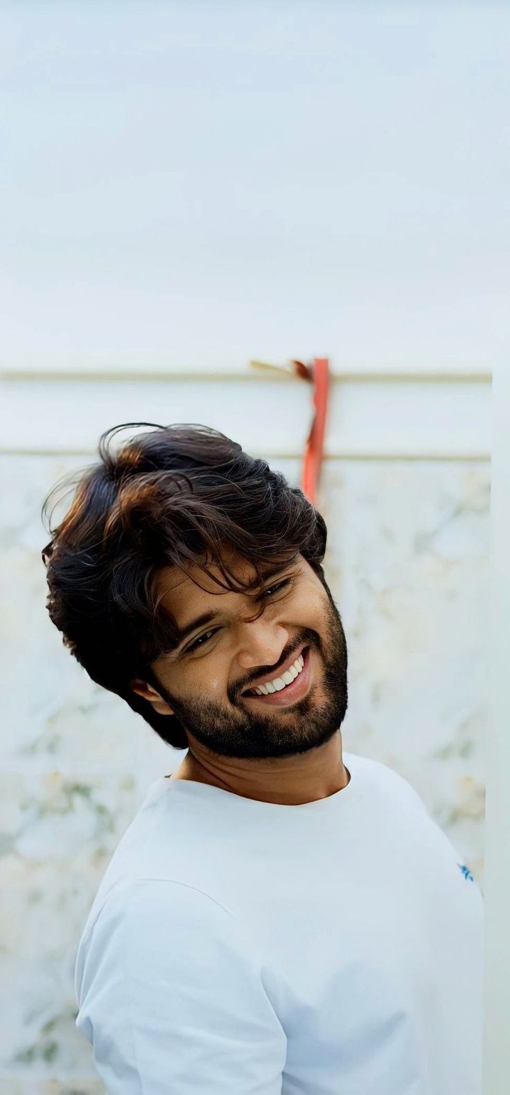 a man with a beard smiling at the camera