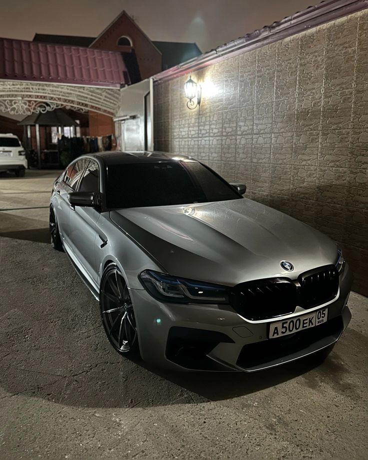 a silver car parked in front of a building