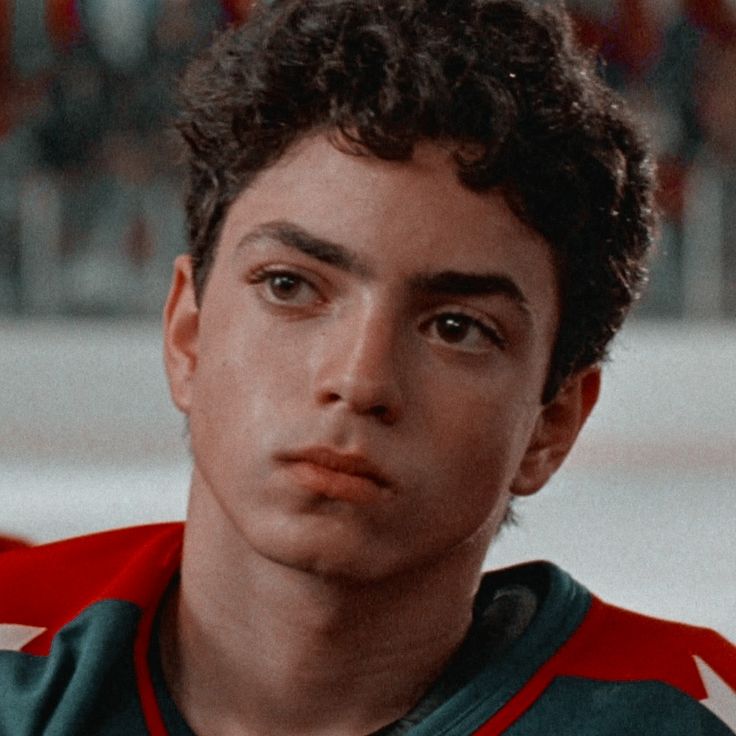 a close up of a young man wearing a jersey with stars on the chest and shoulders