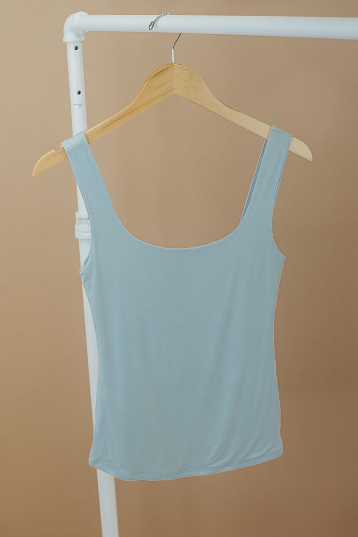 The Double Layered Reg Length Tank is a must-have for a casual summer wardrobe, offering the best basics with its double-layered design that adds a touch of uniqueness to a cute and solid shirt. This stylish and lightweight tank effortlessly embodies a summer aesthetic. Double Layered Tee Fixed straps Premium ribbed knit fabrication Fit: Fitted; Generous stretch Fabric: 92% Nylon 8% Spandex Model Specs: Emily is wearing a size small in the photo. Syd is wearing a size large. How will this item f Casual Summer Wardrobe, Dusty Sage, Everyday Chic, Layered Design, Chic Boutique, Layers Design, Basic Tees, Layering Pieces, Summer Aesthetic