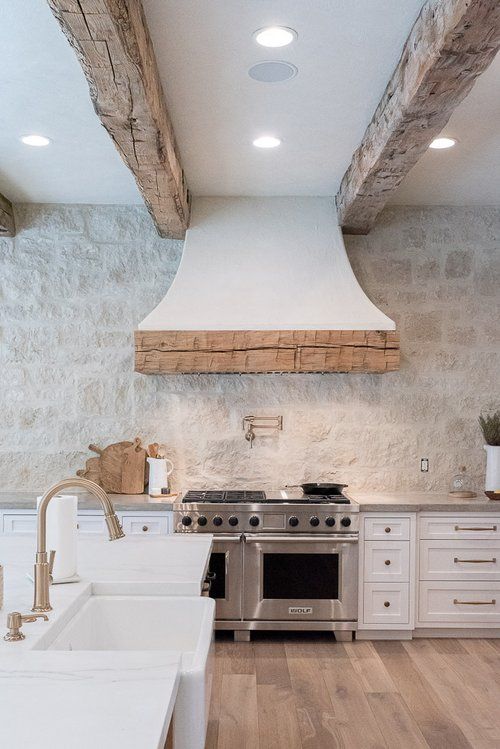 a kitchen with an oven, stove and sink in it's center island area