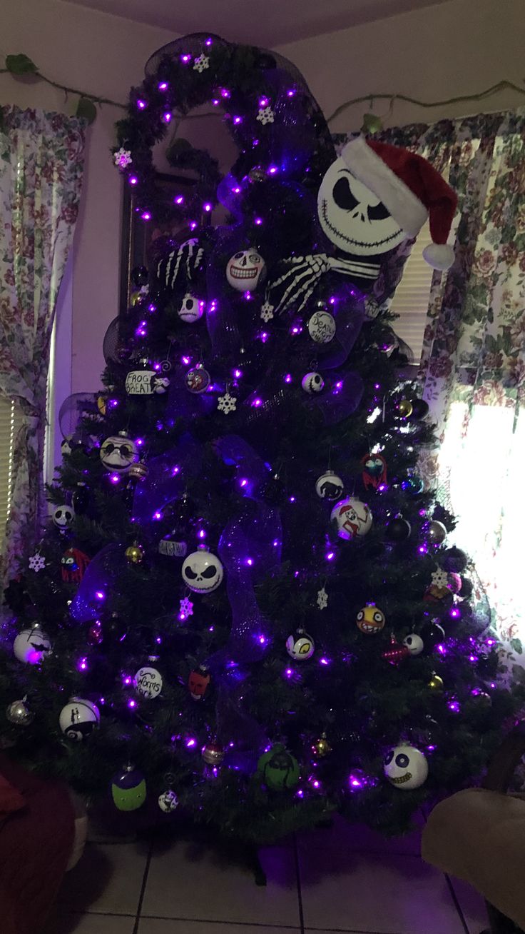 a decorated christmas tree with purple lights