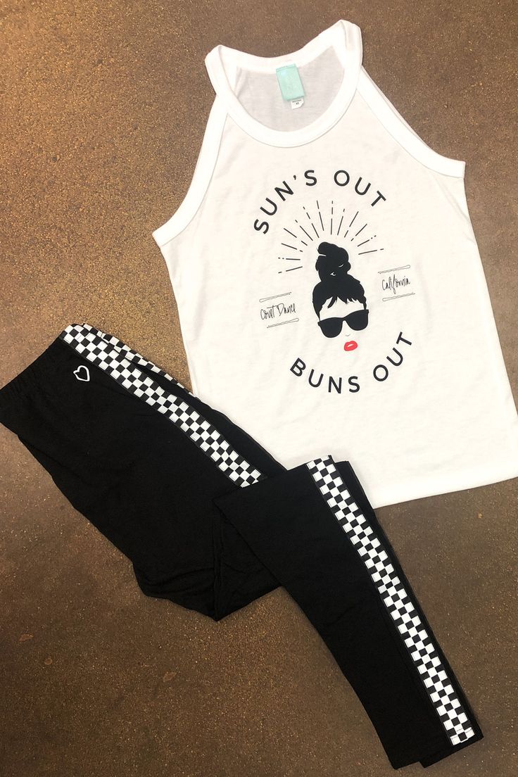 two pieces of clothing sitting on top of a brown floor next to an object that says sun's out, buns out