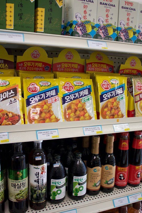 the shelves are stocked with various types of food items and drinks for sale in korean stores