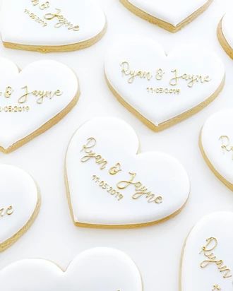 many heart shaped cookies with names on them