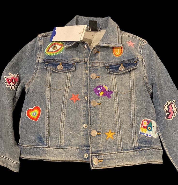 Raising a little Wildflower  Reworked denim jacket with vinyl back patch and finished with a variety of child friendly patches to both front and back. These can be personalised to suit your little Wildflower. All sizes available Multicolor Denim Outerwear With Patches, Trendy Outerwear With Logo Patch For Spring, Trendy Spring Outerwear With Logo Patch, Trendy Cotton Denim Jacket With Embroidered Patch, Cute Denim Outerwear With Patches, Cute Denim Jacket With Patches For Fall, Cute Patched Denim Jacket For Fall, Playful Cotton Denim Jacket With Pockets, Cute Denim Jacket With Patches For Spring