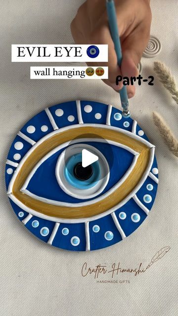 someone is painting an evil eye on a piece of paper