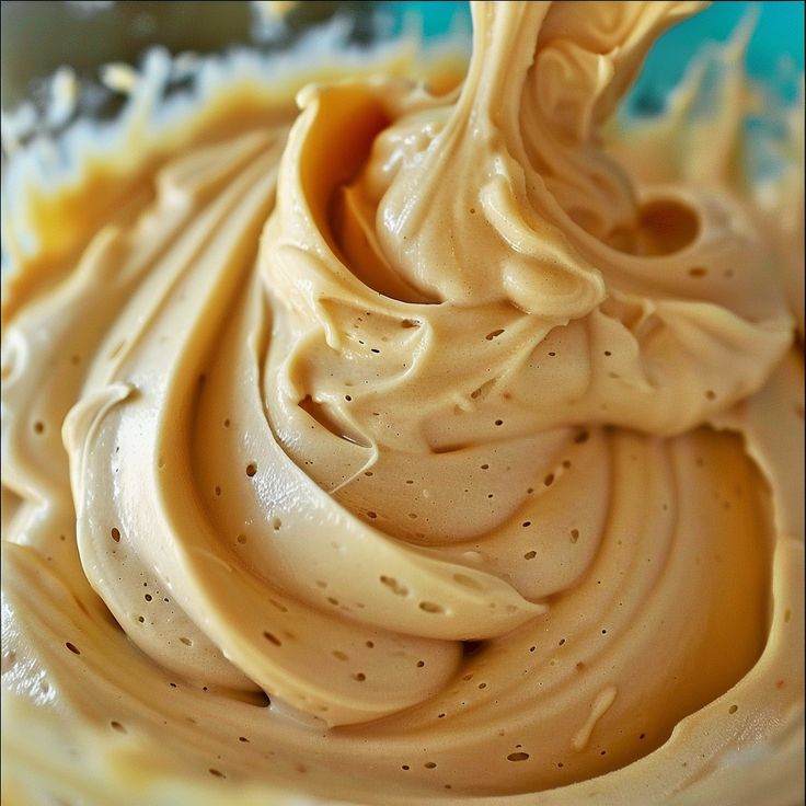 a close up view of the inside of a frosted cupcake with icing on it