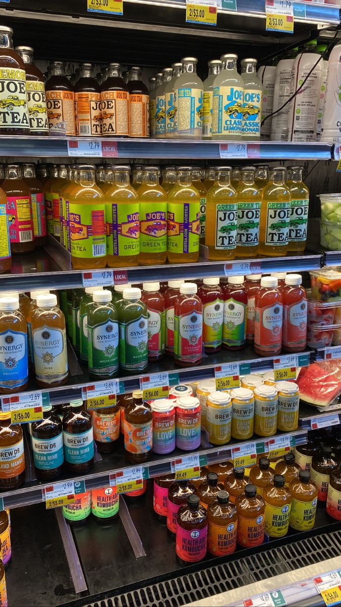 a display in a grocery store filled with lots of different types of juices and condiments