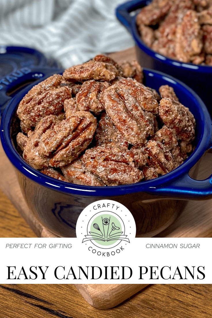 two blue bowls filled with candied pecans sitting on top of a wooden table