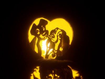 the silhouettes of two people and a dog in front of a heart shaped moon