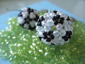 two black and white beaded rings sitting on green grass