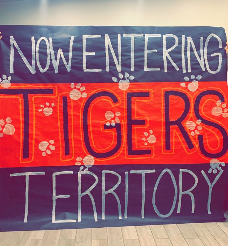 a banner that says now entering tigers territory with paw prints on the front and side