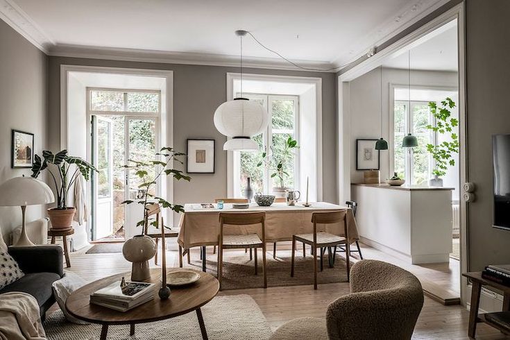 a living room filled with furniture and lots of windows