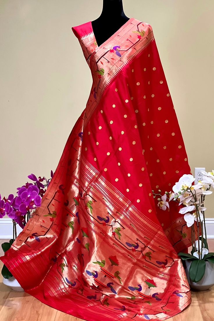 This exquisite regal paithani saree is handwoven in vermillion red color. Traditional gold zari coin buttis adorn the body while the golden zari border is decorated with handwoven brocade border. The elaborate pallu is woven with colorful peacocks along with winding vines and flowers. The saree comes with plain blouse with matching borders. Approximate Length 6.5 mtrs (inclusive of blouse length)Height - 48- 52" Approximate weight - 1.8 lbs Saree comes with fall and picot done. Blouse piece is c Luxury Cutdana Paithani Silk Dupatta, Ceremonial Gold Paithani Silk Lehenga, Ceremonial Gold Lehenga In Paithani Silk, Red Paithani Silk Traditional Wear With Motifs, Traditional Paithani Silk Wear With Zari Weaving, Paithani Silk Traditional Wear With Zari Weaving, Paithani Silk Saree With Motifs For Puja, Festive Paithani Silk Dupatta With Zari Weaving, Red Paithani Silk Dupatta For Puja