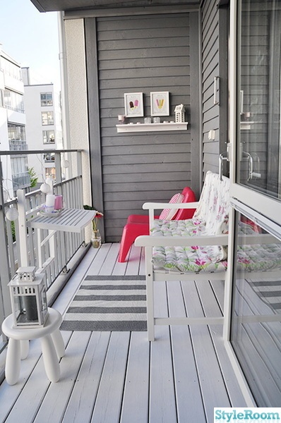 a balcony with two chairs and a table on it