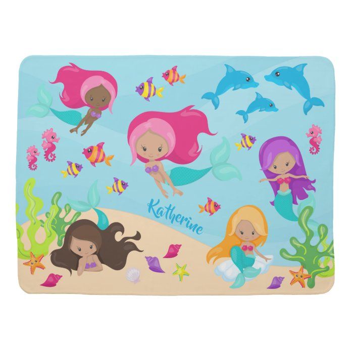 a spiral notebook with mermaids and dolphins on it