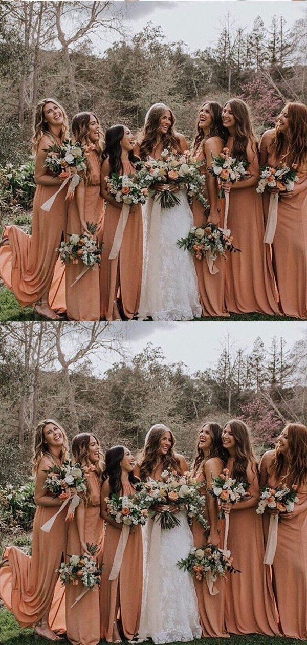 a group of women standing next to each other in front of trees and grass with flowers