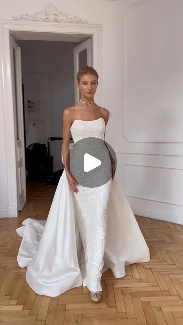 a woman in a white wedding dress standing on a wooden floor with an open doorway