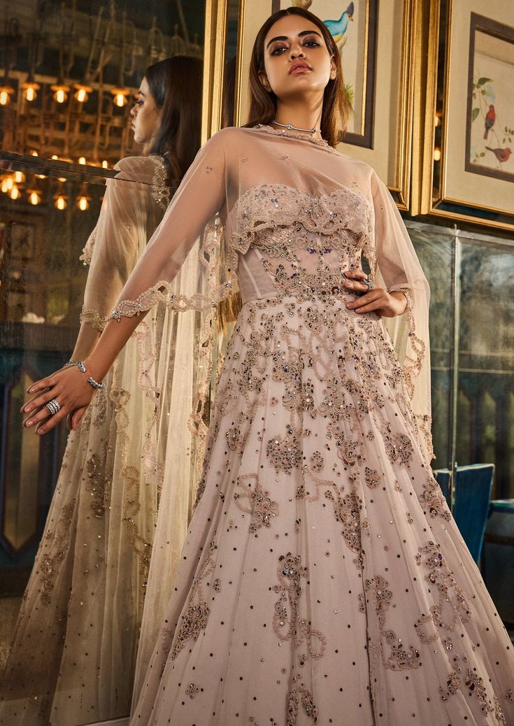 Smoked ivory chiffon kamdani anarkali with zardosi embroidery and tulle dupatta. Anarkali Style Embellished Cream Sharara, Beige Semi-stitched Gown For Reception, Beige Dress With Intricate Embroidery For Reception, Beige Semi-stitched Dress For Reception, Semi-stitched Sheer Dupatta Gown In Georgette, Festive Georgette Gown With Sheer Dupatta, Cream Embellished Dupatta In Traditional Drape, Beige Anarkali Gown With Sheer Dupatta, Cream Embellished Dupatta With Traditional Drape