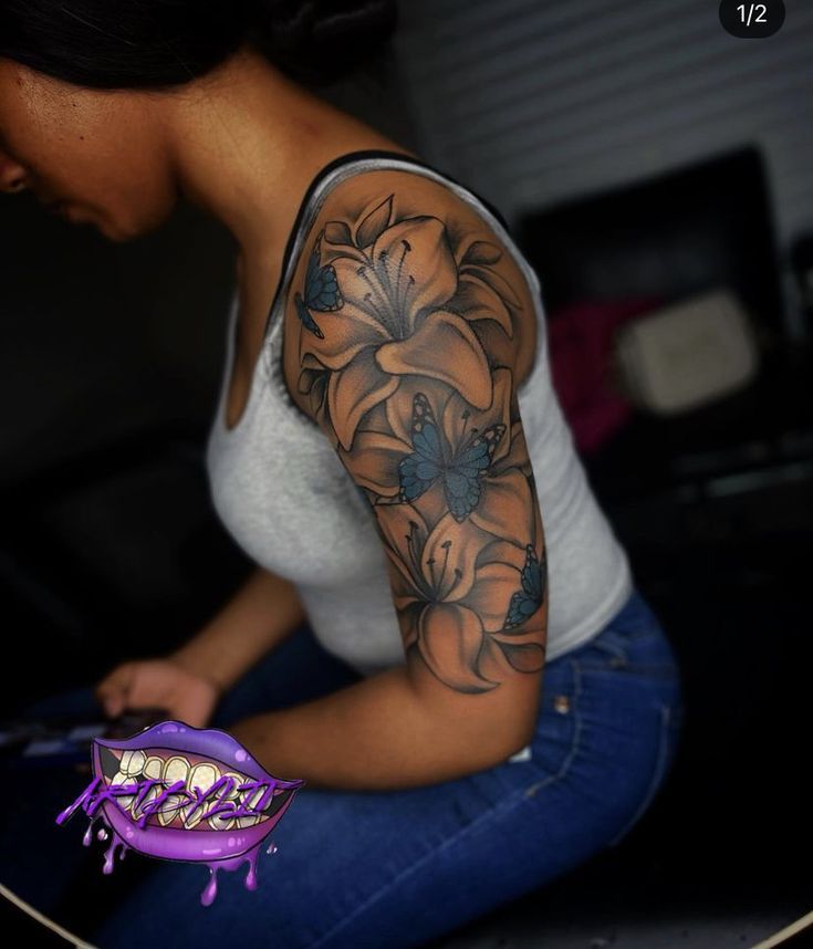 a woman with a tattoo on her arm is sitting next to a skateboard and holding a toothbrush