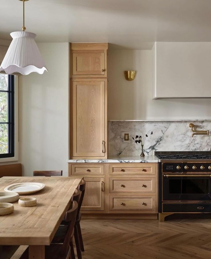 a kitchen with an oven, stove and dining room table in it's center