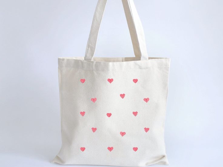 This lightweight eco friendly pink heart canvas cotton tote bag is the perfect every day accessory. Whether you are using it to run errands or just carrying around everyday essentials, this cute minimalist tote is cute all year long.  The bag features 20" handles (made from the same canvas), making it easy to carry even with a week's worth of shopping. Printing options for two sides. Every item is custom produced, made to order, so please note each item is unique and may differ in color slightly Coquette Tote Bag, Minimalist Tote Bag, Heart Tote Bag, Minimalist Tote, Heart Canvas, Canvas Making, Eco Conscious, Everyday Essentials, Tote Bag Design