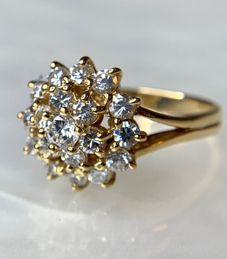 A whimsical and timeless Cubic Zirconia ring set in genuine 14k yellow gold. This is an ideal gift for her: girlfriend, wife, mother, daughter for any of life's milestones or special occasions: birthday, graduation, valentine's day, Mother's day, christmas, or holiday! Gold Cluster Ring With Cubic Zirconia Stamped 14k, Dazzling Yellow Gold Cluster Ring With Rose Cut Diamonds, Yellow Gold Cubic Zirconia Cluster Ring With Prong Setting, Yellow Gold Cluster Ring With Brilliant Cut Cubic Zirconia, Gold Flower Ring With Cubic Zirconia Center Stone, 14k Stamped Cubic Zirconia Cluster Ring, Heirloom Style Cluster Cubic Zirconia Rings, Dazzling 14k Gold Cluster Ring For Formal Occasions, Classic Yellow Gold Flower Ring With Center Stone