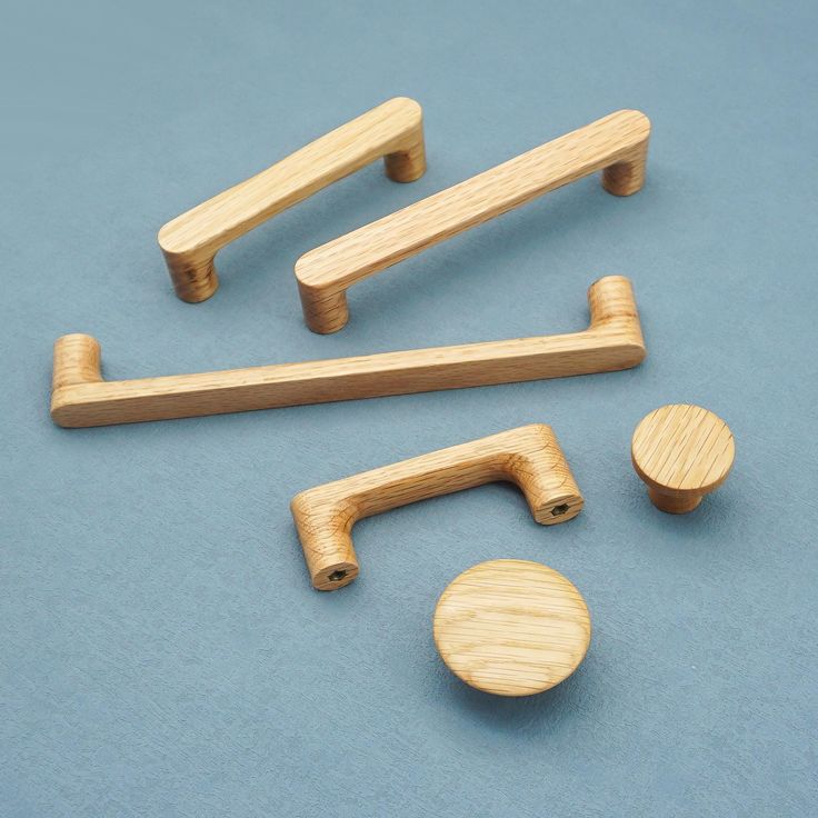 wooden handles and knobs on a blue surface