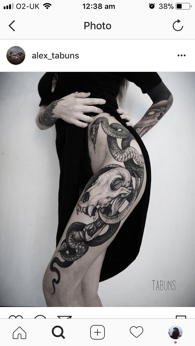 a woman with tattoos on her arm and leg