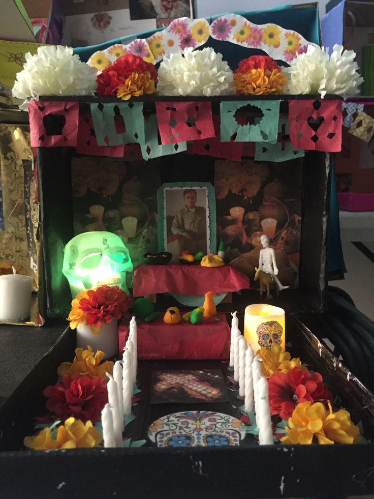 a small shrine with candles and flowers on it