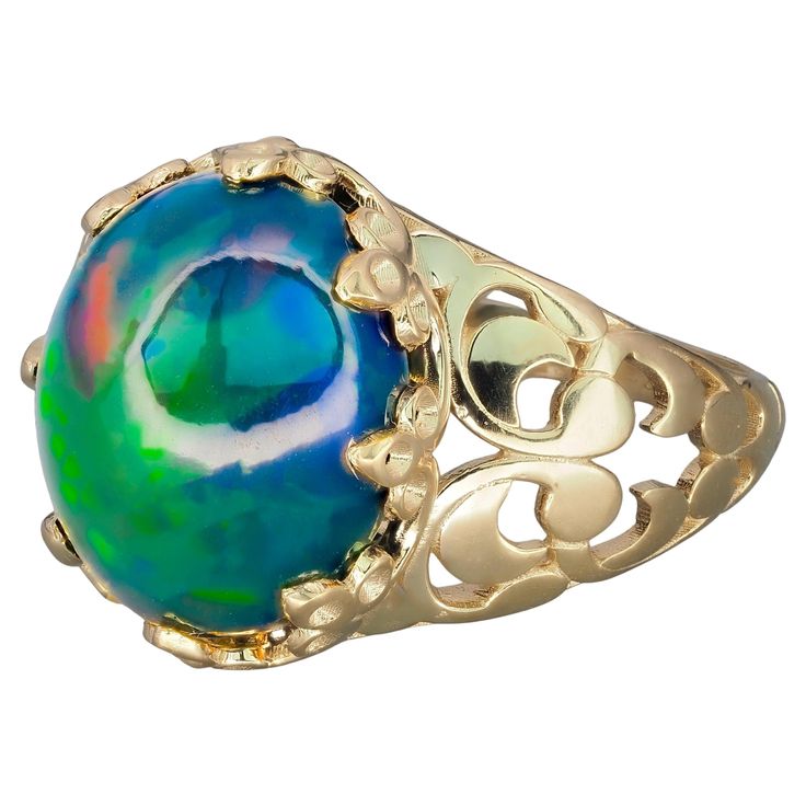 Black opal vitage style ring in 14 karat gold. Ethiopian opal cabochon ring. October Birthstone opal ring. Multicolor opal ring. Material: 14 karat gold Weight: 2.6 - 3 g. (depends from ring size) Set with opal , color - green, blue, red - multy Oval cabochon cut, 2.2-2.5 ct. in total Clarity: Semi Transparent with iclusions Origin: Ethiopia If you wish to see opal best colors and brightness, use a cool desk lamp, or stand directly under a cool LED house light. All opals will look very nice when Cool Desk, House Light, Led House, Opal Color, Cabochon Ring, October Birthstone, Opal Ring, October Birth Stone, Black Opal