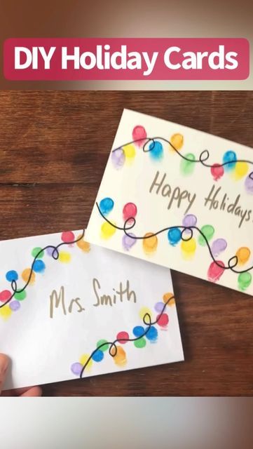 two handmade holiday cards with the words happy holidays written on them and decorated with lights