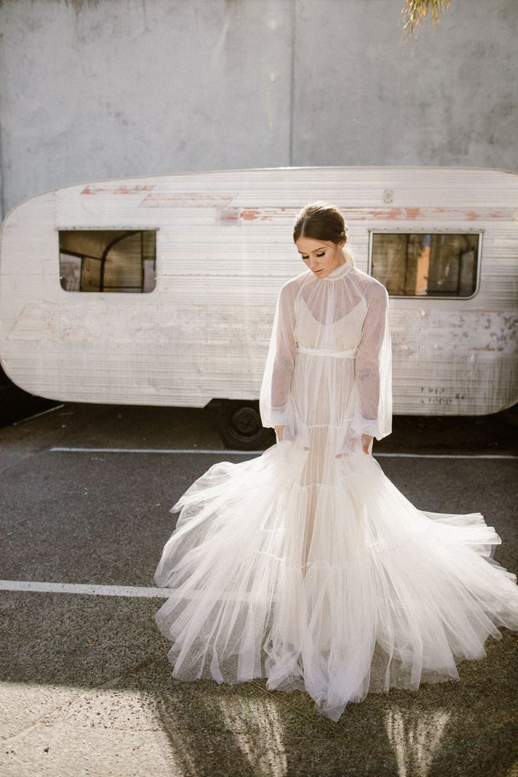 a woman standing in front of a trailer