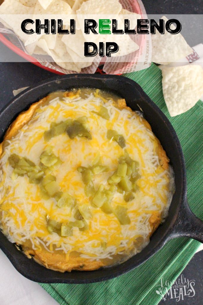 a cheesy dip in a cast iron skillet with tortilla chips on the side