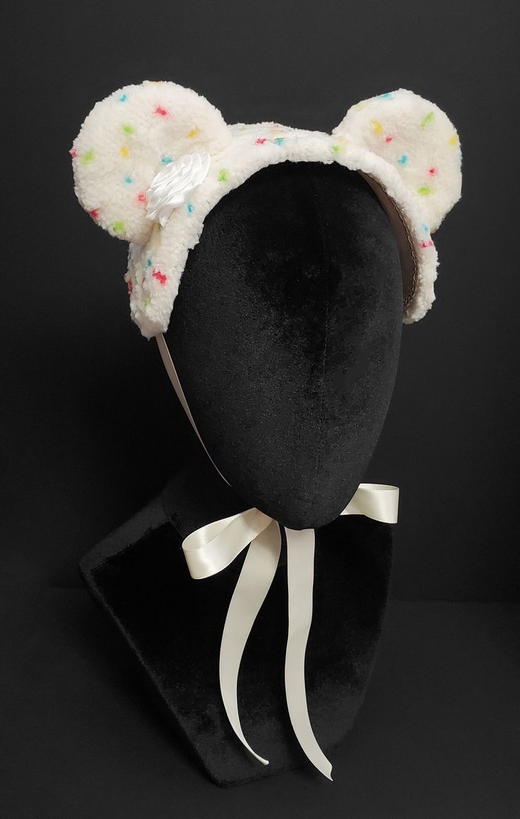 This is an Ice Cream Bear bonnet designed and handmade by me. It is made of a plush ivory fabric with an ivory cotton fabric underside with ivory braid gimp trim. The bonnet is embellished with plush bear ears, handsewn to the base, an ivory satin ribbon butter cream dollop, and hand dotted rainbow funfetti. The piece fastens with an ivory double face satin ribbon that ties into a bow beneath the chin. Crazy Colorful Outfits, Cake Batter Ice Cream, Funfetti Cake, Ivory Fabric, Kawaii Fashion Outfits, Bear Ears, Head Accessories, J Fashion, Candy Land